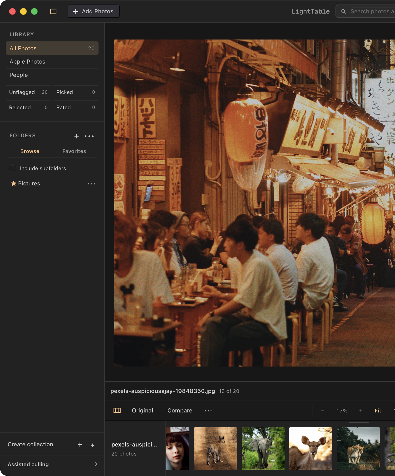 The left half of LightTable’s Film workspace, with the library sidebar beside a colorful lantern-lit alley photograph